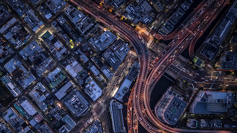 Aerial view of busy roads and streets in city at night time